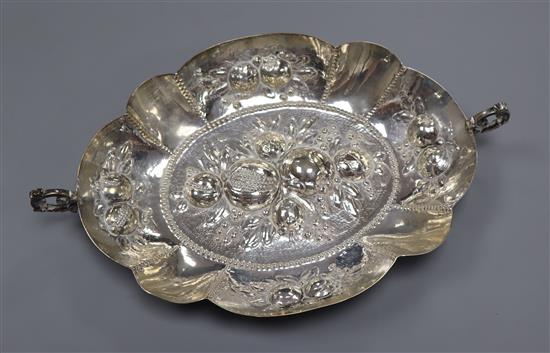 A German 800 white metal two handled oval dish, embossed with fruit, 29cm over handles.